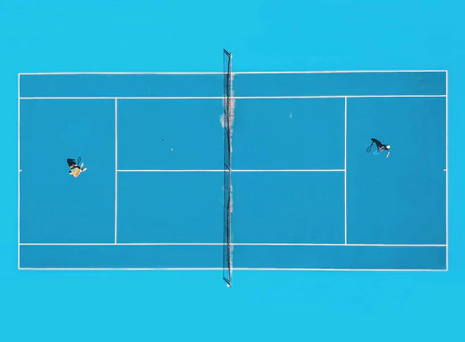 Tennis match on an aqua blue court.