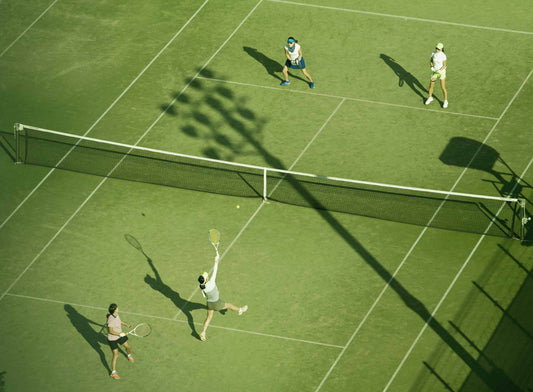 Woman playing tennis on green court. 