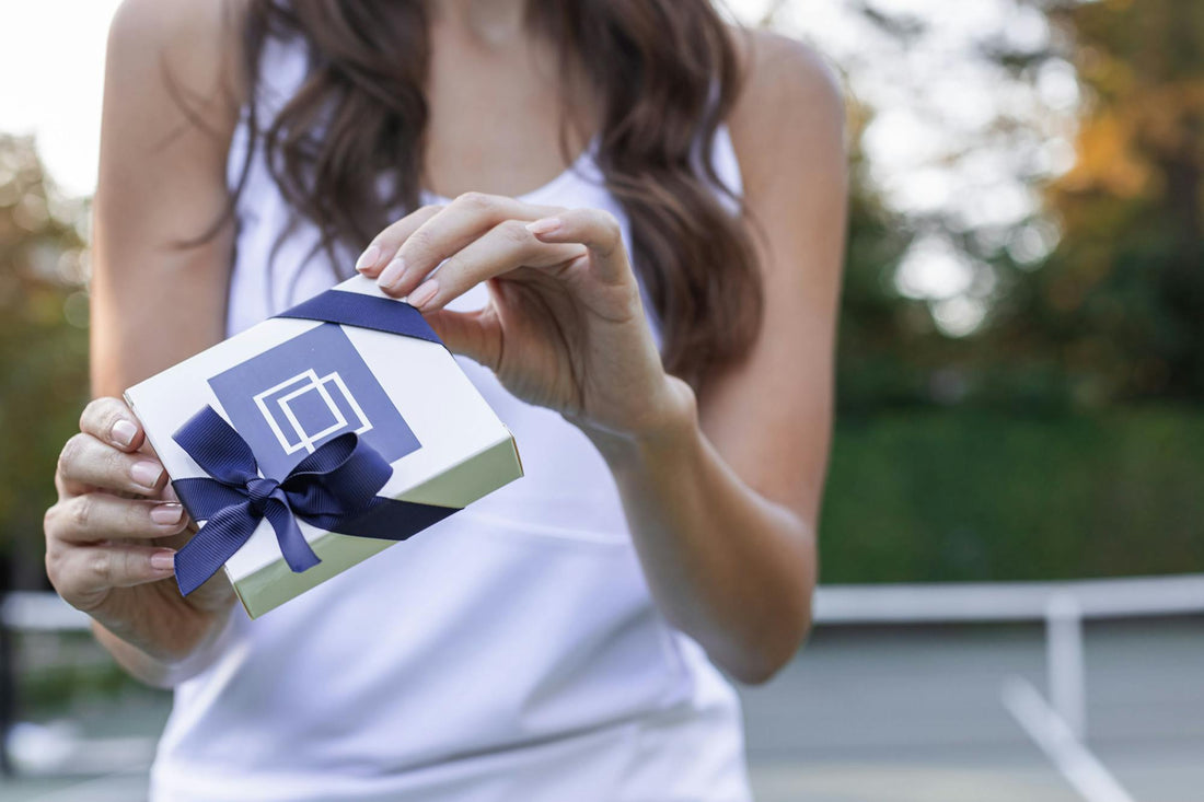 Woman holding a giftbox with doubletake branding